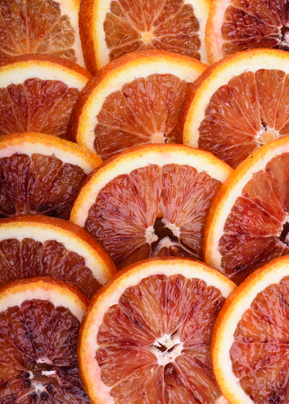 Background of ripe juicy slices of blood orange. Textured. Verticalの写真素材
