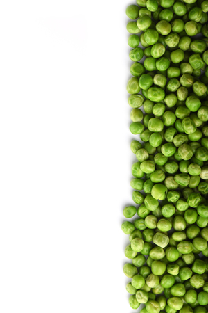 Green peas isolated on white background. Upright. Copy space.の写真素材