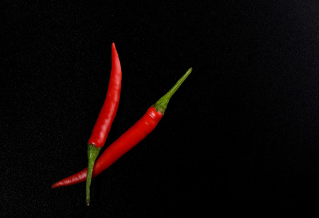 Pods of red hot pepper isolated on black color background. Copy spaceの写真素材