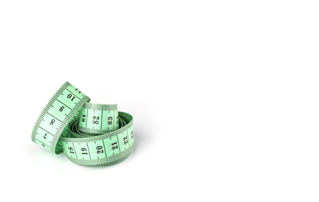 Tailoring centimeter tape twisted into a spiral isolated on a white background. Copy space