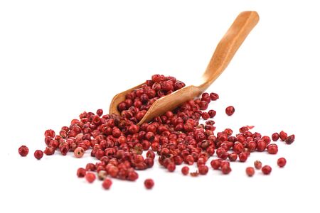 Red hot pepper peas on a wooden culinary scoop isolated on a white background. Copy space