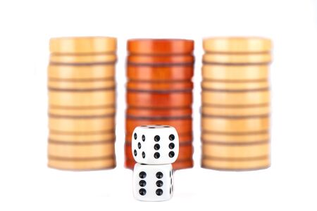 Several checkers and dice isolated on a white background. Board games concept. Copy space.