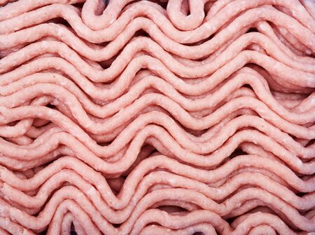 Minced turkey as background. The texture of minced turkey. Diet product. Close up.