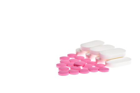 Pink and white pills isolated on white background.の写真素材