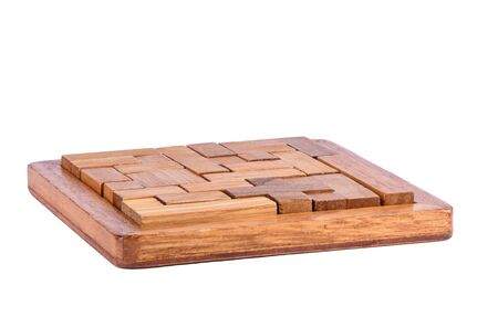 Three-dimensional wooden pentamino board game on a white background. Board games concept. Copy space.の写真素材