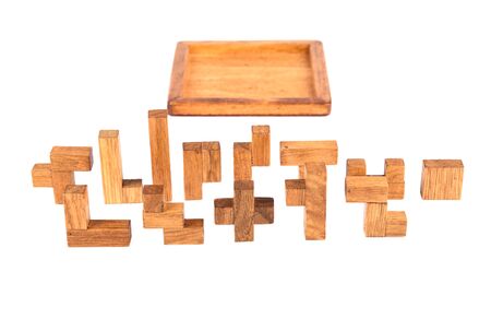 Details and box three-dimensional wooden pentamino board game on a white background. Board games...