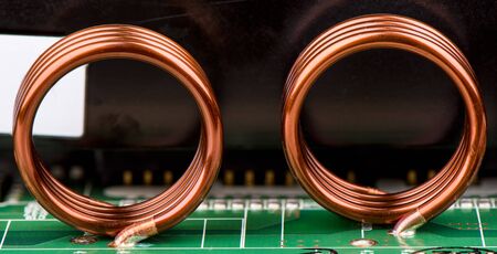 Electronic components. Inductors are soldered to the electronic board. Close up.の写真素材