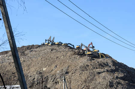 MOSCOW REGION, RUSSIA, MARCH 26, 2020. A group of working excavators on a training ground against a...