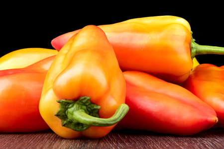 Sweet peppers of the new harvest on a wooden table.