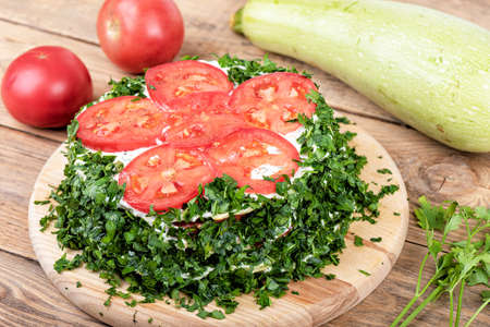 Pie made from squash pancakes, tomatoes and herbs.の写真素材