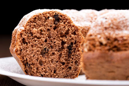 Macro shot texture of homemade cupcake slice with chocolate chips.
