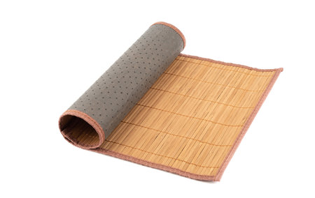 Rolled up bamboo food mat isolated on white background. Traditional kitchen utensils.の写真素材