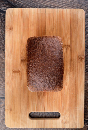 Top view of rye bread on a wooden cutting board. Top crust of rye bread.の写真素材