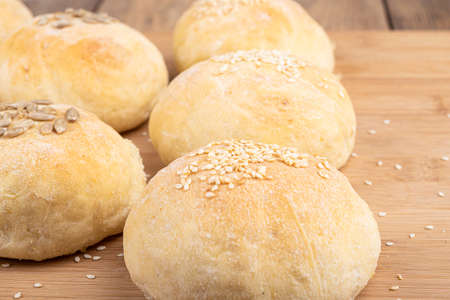 Selective focus on homemade buns with sesame and sunflower seeds. Focus on the foreground. Freshly...