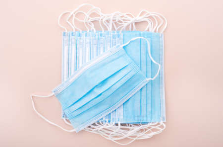 A protective medical mask lies on a pile of masks.の写真素材