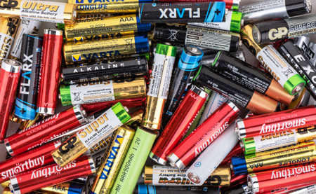 MOSCOW, RUSSIA - November 6, 2021: Abstract background from used AAA batteries from different...