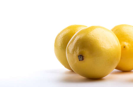 Close-up of ripe lemons on a white background. Copy space.の写真素材