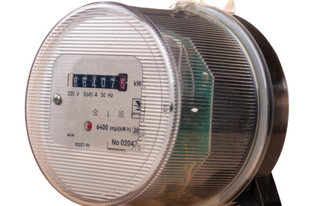 Close-up of an electric analogue meter isolated om white background.の写真素材