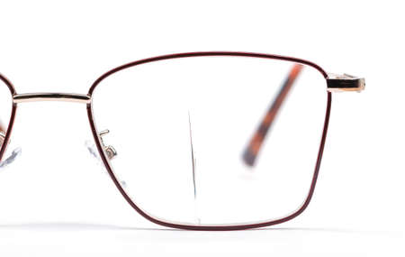 Close-up of a crack in the glass of glasses. Glasses on a white background.の写真素材