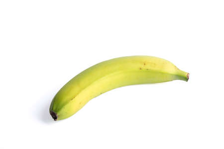 Unripe banana on a white background with a shadow. copyspace.の写真素材