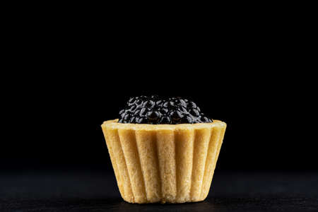 Tartlet with black caviar on a dark background.の写真素材