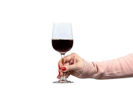 A woman's hand holds a glass of red wine against a white background. copyspace.の写真素材