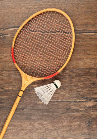 Racket and plastic shuttlecock for playing badminton on a wooden background. outdoor games.の写真素材