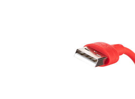 Close-up of a usb connector on a red cable on a white background.の写真素材