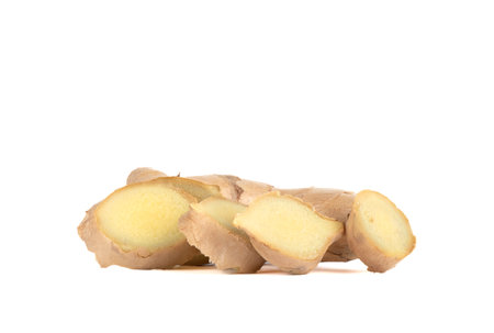 Ginger root with pieces cut off from it on a white background. copyspace.