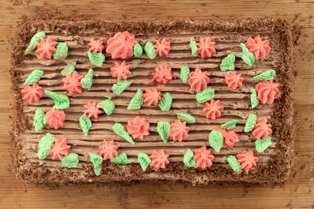 Top view biscuit cake decorated with colorful buttercream flowers. homemade cake.
