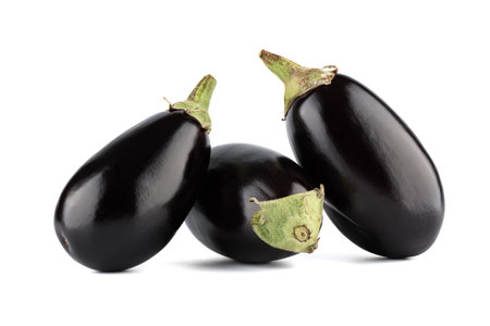 Whole fresh unpeeled eggplants on a white background.の写真素材