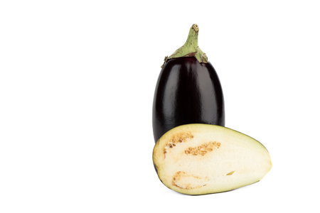 A whole eggplant and a half on a white background with space for text. Close up.の写真素材