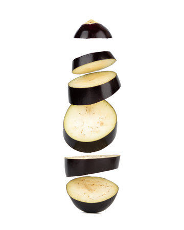Levitating pieces of sliced eggplant on a white background. Copy space.の写真素材