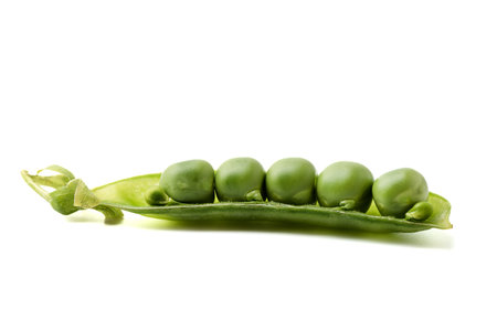 Half a pod with peas isolated on a white background. Copy space.の写真素材