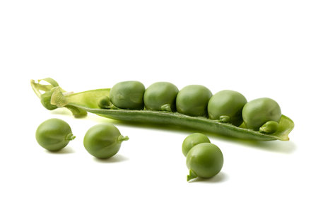 Ripe peas on a white background and half a pea pod. Copy space.の写真素材