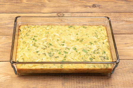Baked unsweetened burek in a glass baking dish on a wooden background. Close up.の写真素材