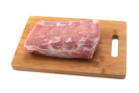 Raw pork chop meat on cutting board over white background. Healthy eating.の写真素材