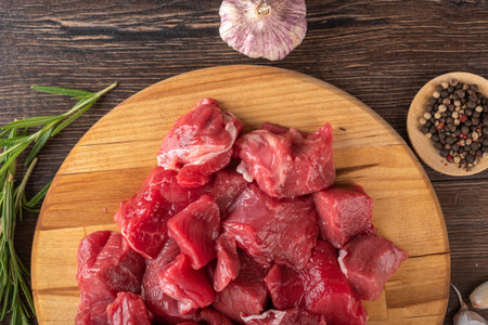 Close-up of goulash - pieces of beef or lamb meat on a cutting board. Healthy eating.