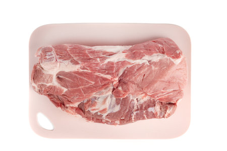 Top view of raw pork meat on a plastic cutting board.の写真素材