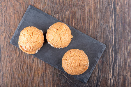 Top view of coconut cookies on a mica serving board.