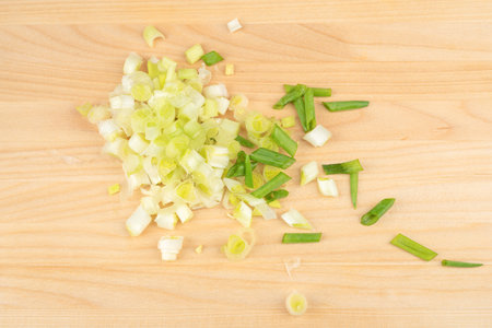 Sliced green onions on a wooden cutting board. Home cooking.の写真素材