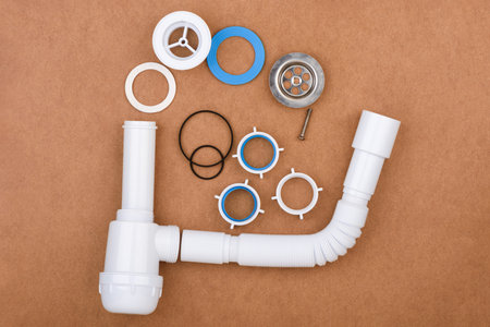 Completely disassembled complete sink drain assembly kit with flexible tube and accessories.の写真素材