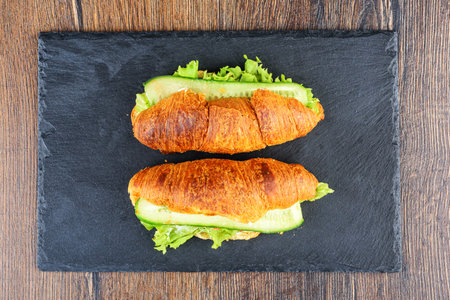 Top view of serving board with freshly baked stuffed croissants. Home cooking.の写真素材