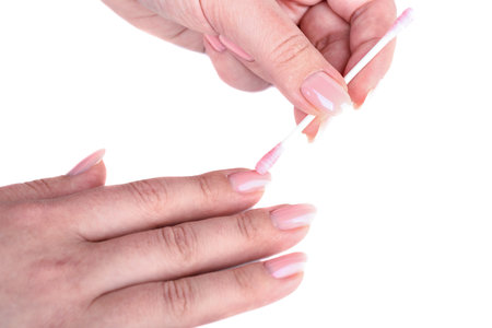 Cleaning women's nails with manicure using a cotton swab. Copy space.の写真素材