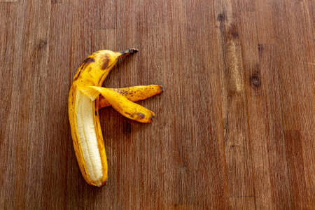 funny banana on brown tableの写真素材