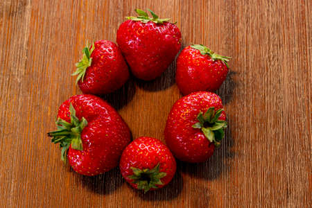 red sweet strawberries on a beautiful brown tableの写真素材