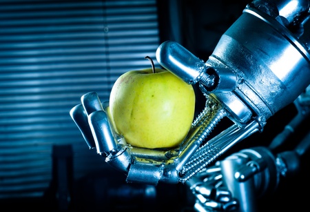 Robot hand holding fresh appleのeditorial素材