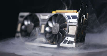 Graphics card with smoke rising and dark background closeupのeditorial素材