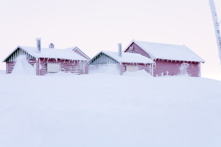 Snow-covered cabins on hardangervidda a stormy winter day 