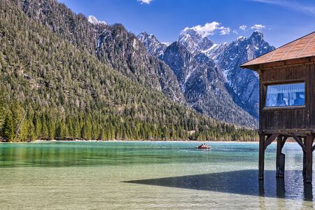 Dobbiaco Lake in front of the mountain ponarma of the Dolomites in South Tyrolの写真素材